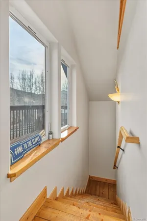 a view of a room with wooden floor and a window