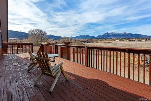 a view of a roof deck with wooden floor and city view