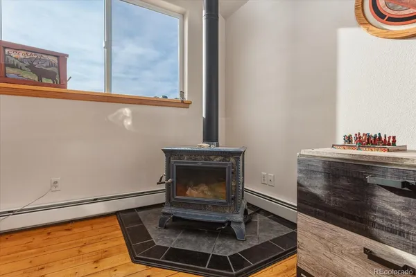 a living room with fireplace and a wooden floor