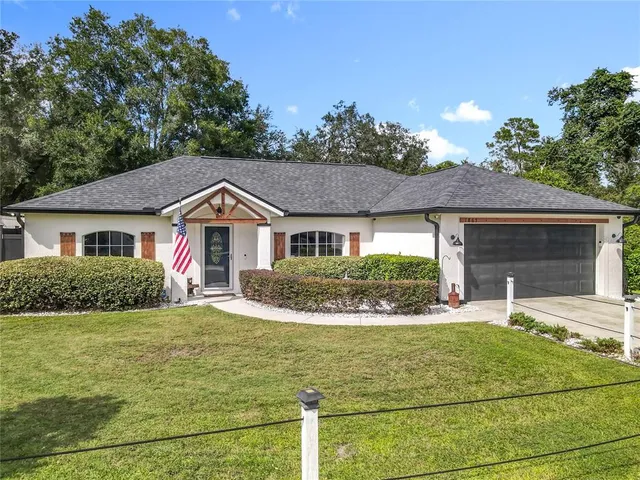a front view of a house with yard and garage