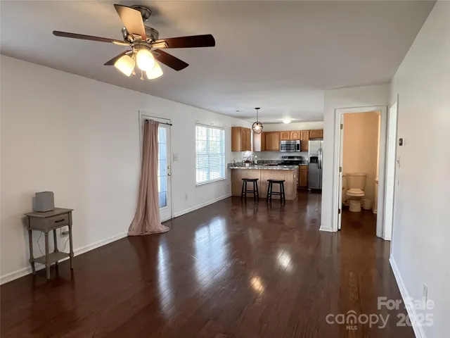 a view of a dining room with furniture a chandelier and wooden floor