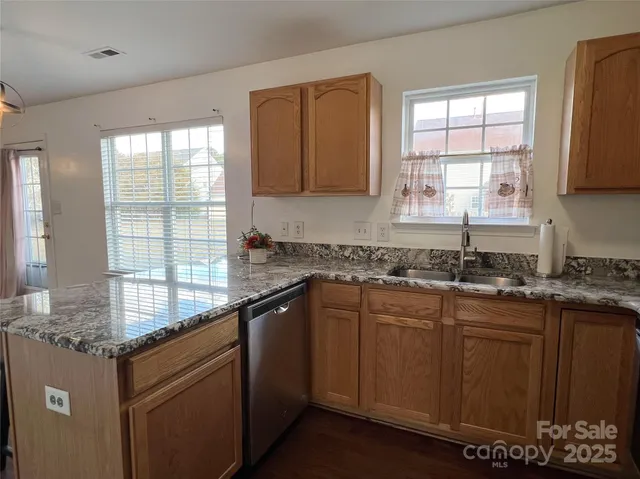 a kitchen with granite countertop a sink and a window