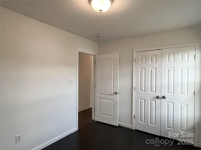 an empty room with wooden floor