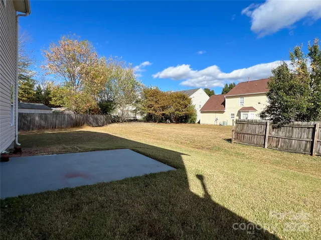 a view of yard with swimming pool and green space