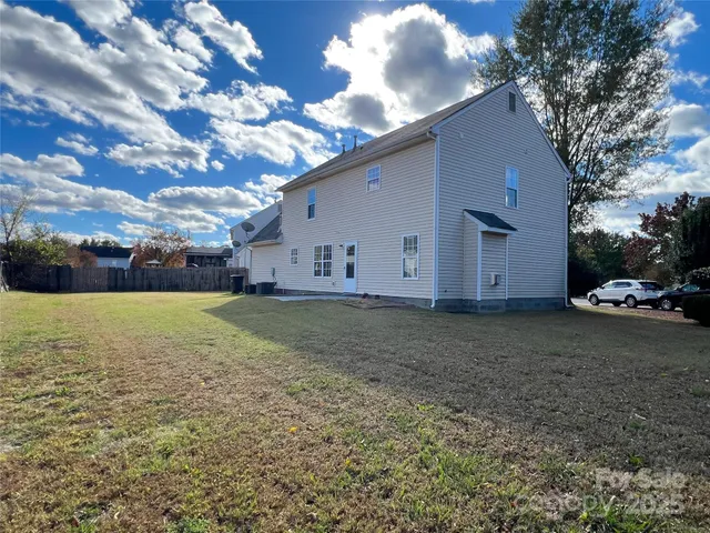 a view of a house with a backyard