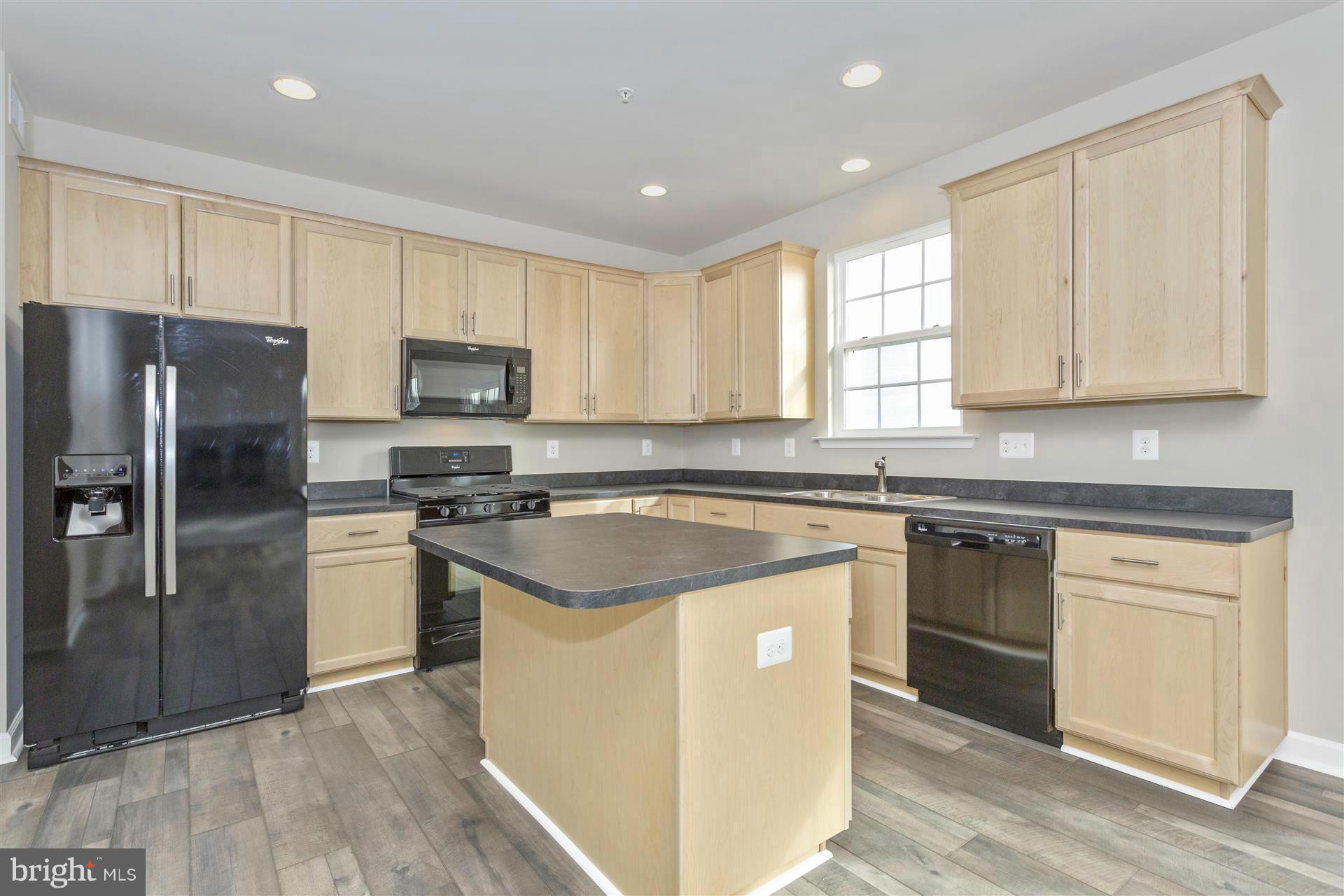 5309 Renn Road Frederick, MD 21703 - Photo 3 of 12 a kitchen with a stove a sink and a refrigerator