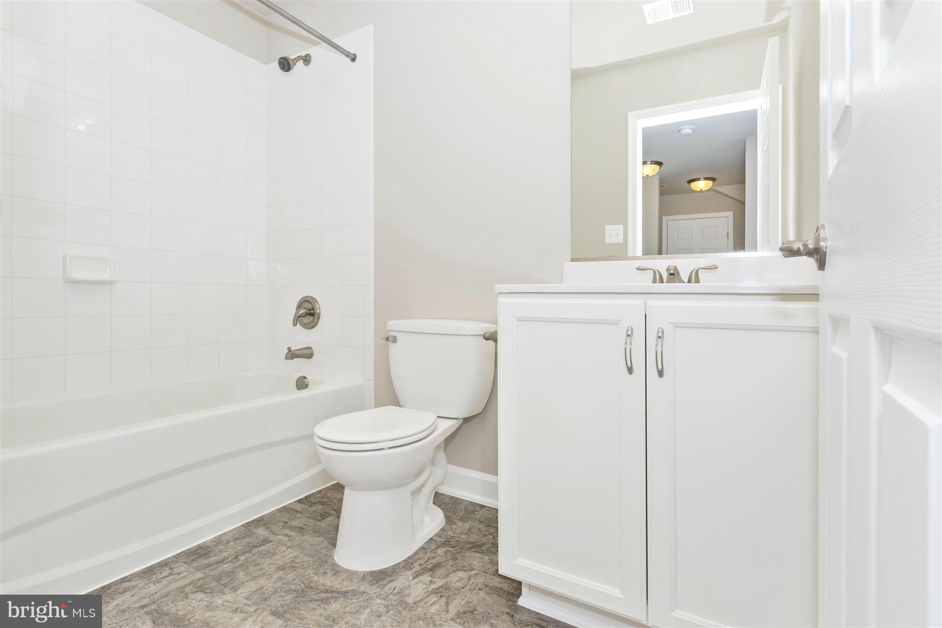 5309 Renn Road Frederick, MD 21703 - Photo 4 of 12 a bathroom with a toilet sink and mirror