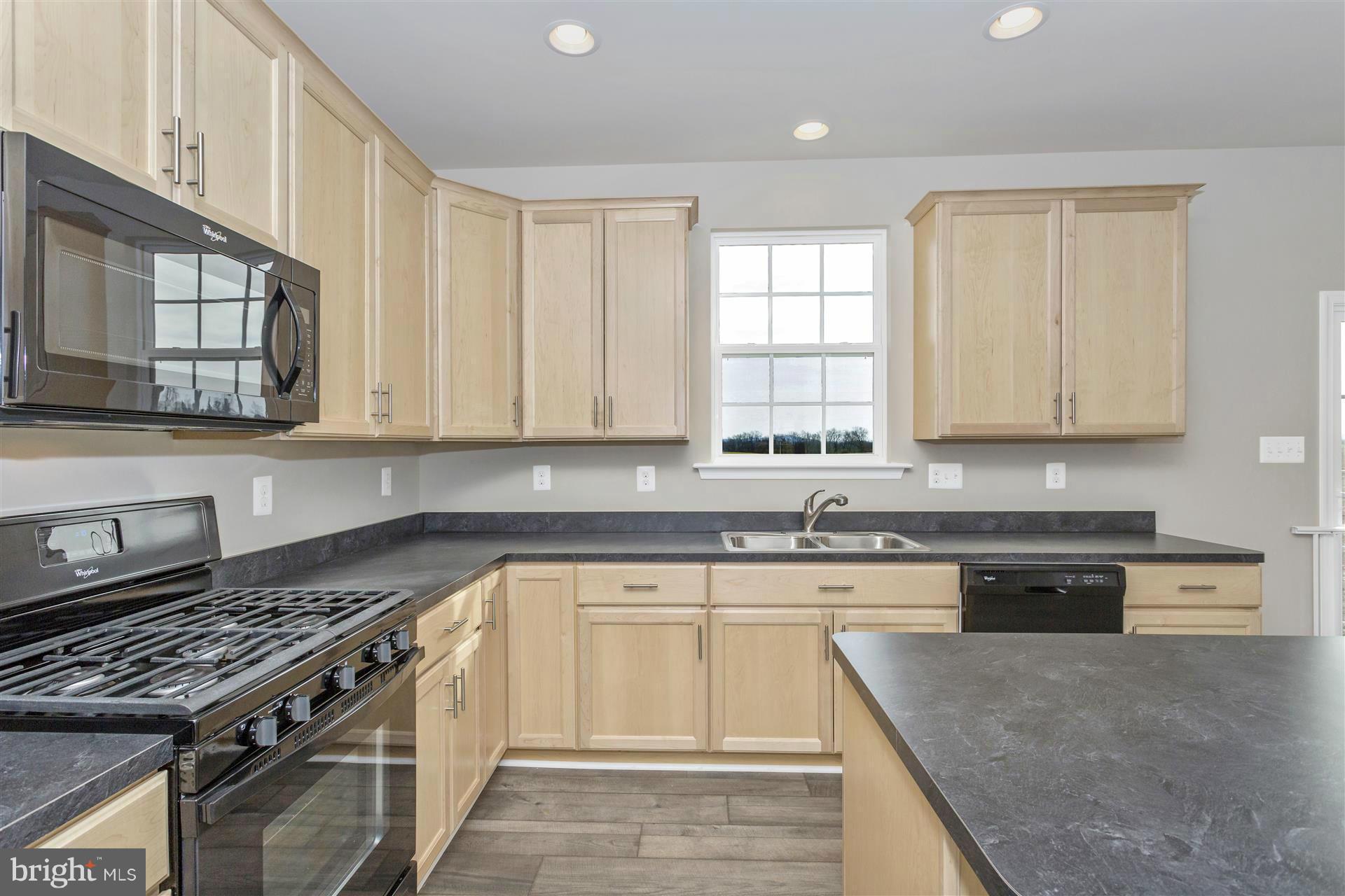 5309 Renn Road Frederick, MD 21703 - Photo 7 of 12 a kitchen with stainless steel appliances granite countertop a stove a sink and a microwave