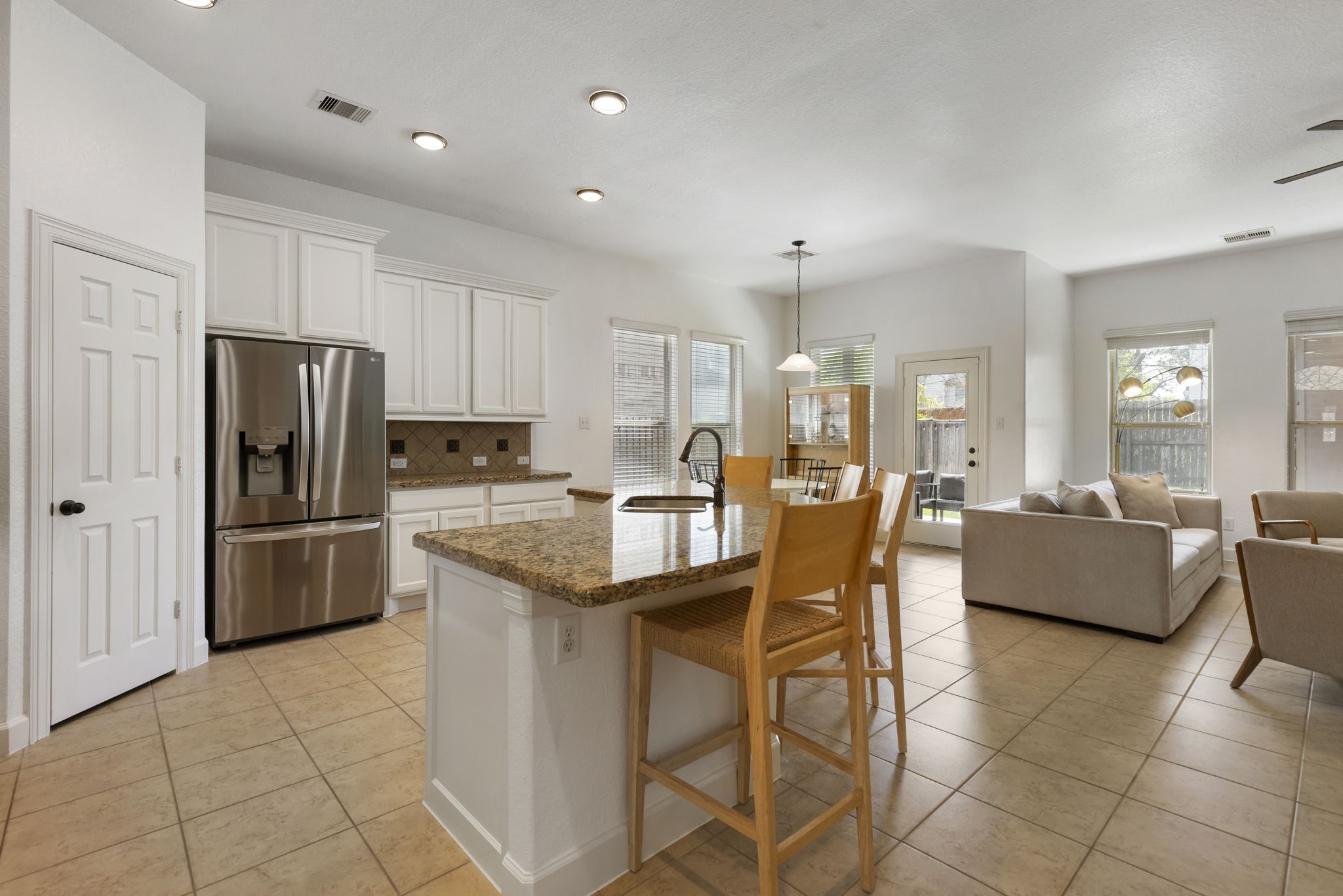 71 Sagamore Ridge Place The Woodlands, TX 77389 - Photo 9 of 34 a kitchen with stainless steel appliances a refrigerator a stove a sink a dining table and chairs