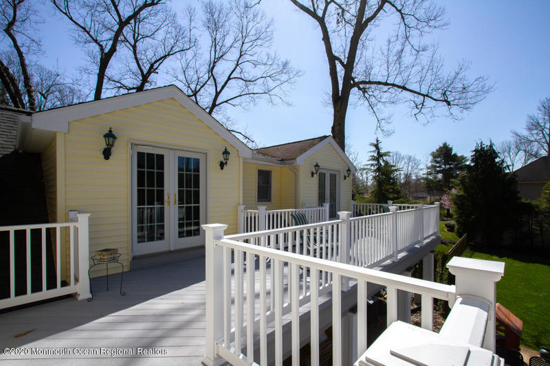 33 Muhlenbrink Road Colts Neck, NJ 07722 - Photo 22 of 45 a view of a house with wooden deck and a large tree