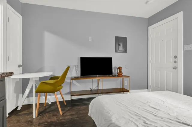 a bedroom with a bed and a flat screen tv