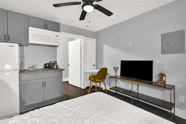 a bedroom with a bed and a flat screen tv