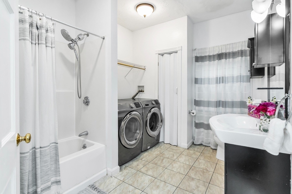 42 D Street Lowell, MA 01851 - Photo 18 of 27 a bathroom with a sink a bath tub and a shower