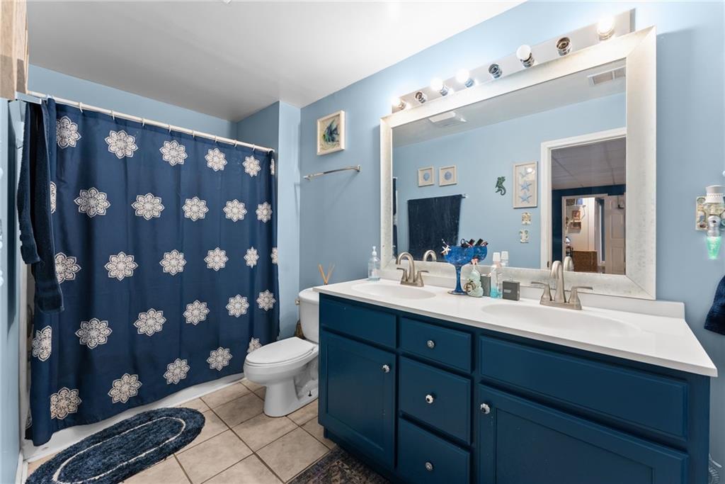 3615 South Bend Road Gainesville, GA 30506 - Photo 28 of 54 a bathroom with a double vanity sink toilet mirror and shower