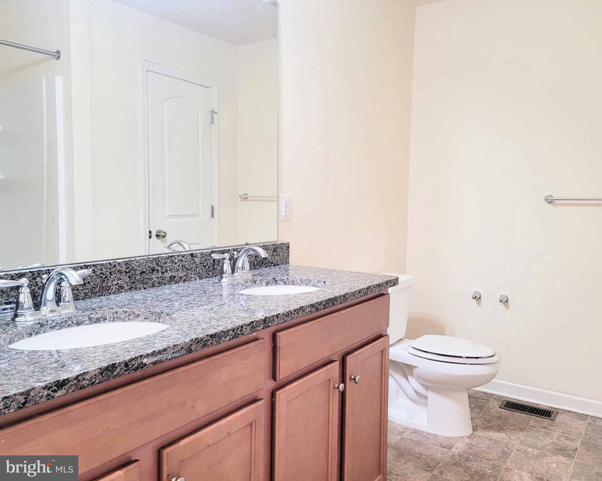 628 Rigel Way Bear, DE 19701 - Photo 13 of 20 a bathroom with a granite countertop sink a toilet and a mirror