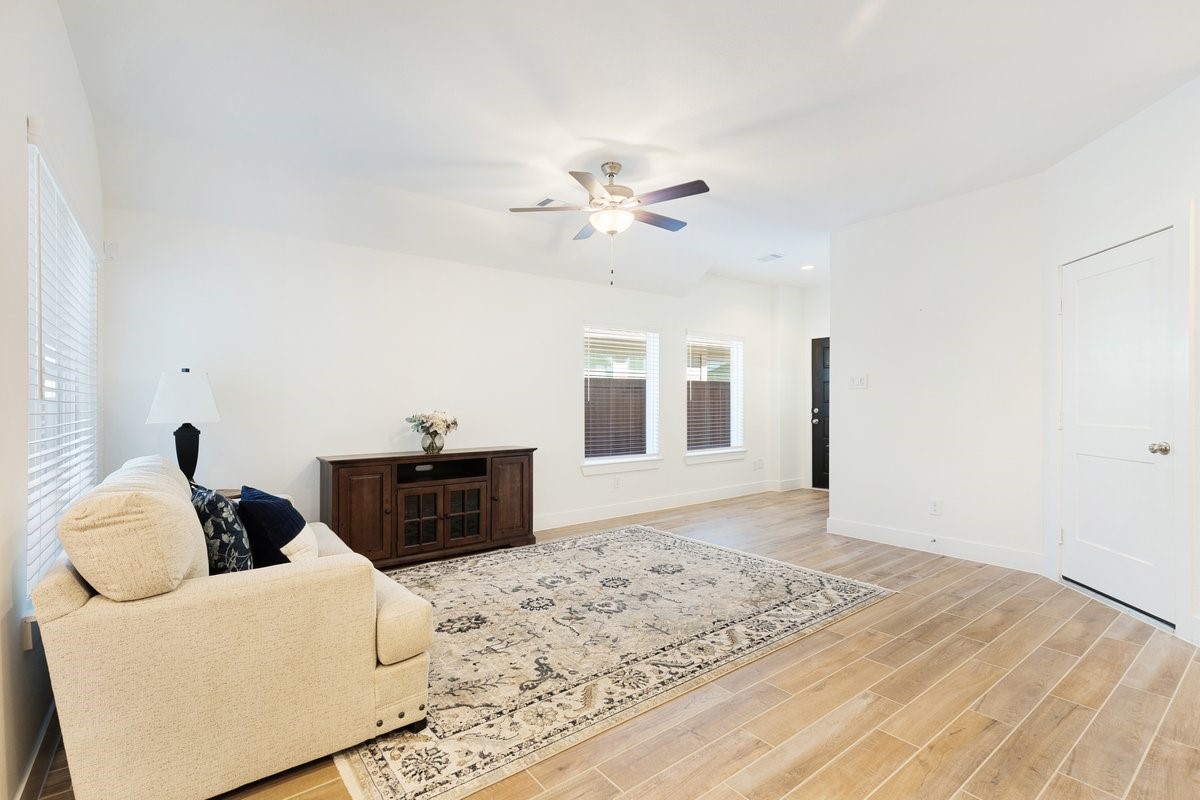10122 Crescendo Way Manvel, TX 77578 - Photo 6 of 24 a living room with furniture and wooden floor