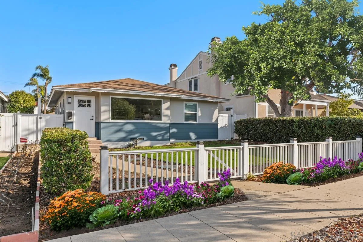 a front view of a house with a garden