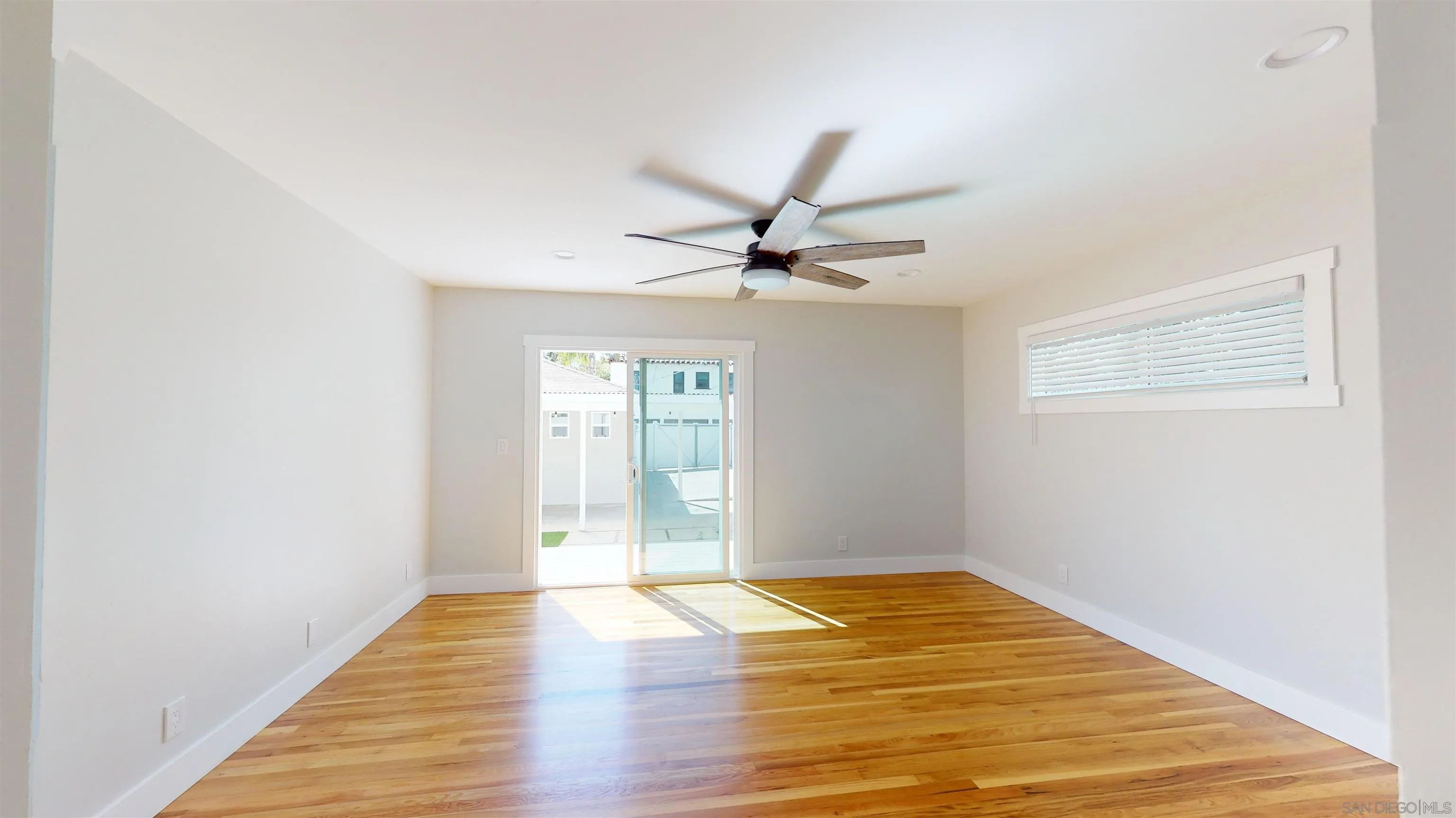 419 H Avenue Coronado, CA 92118 - Photo 12 of 32 a view of a room with wooden floor and a ceiling fan