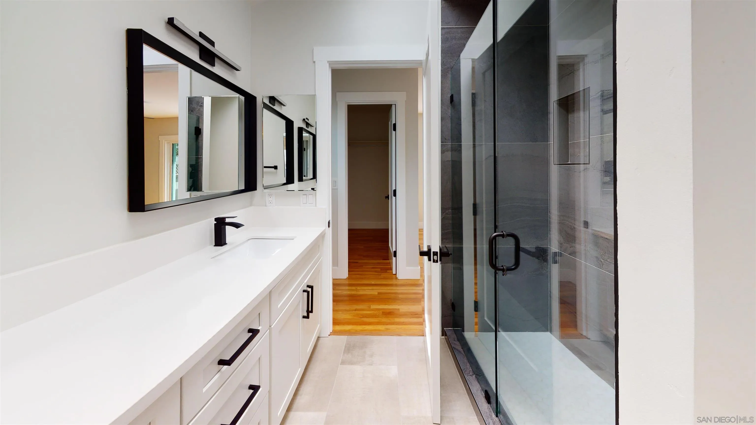 419 H Avenue Coronado, CA 92118 - Photo 13 of 32 a bathroom with a tub sink and mirror