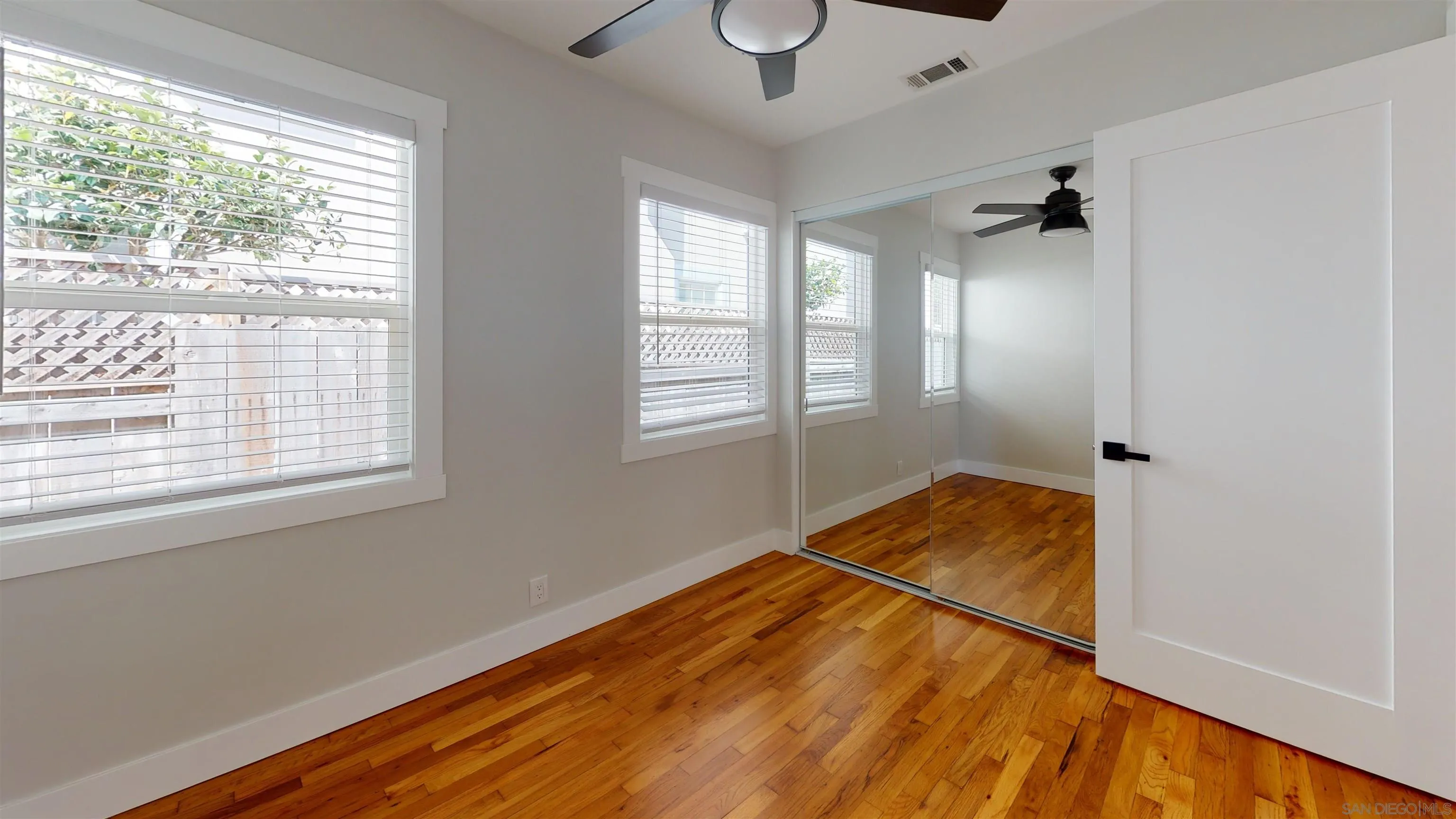 419 H Avenue Coronado, CA 92118 - Photo 15 of 32 a view of a room with wooden floor and windows