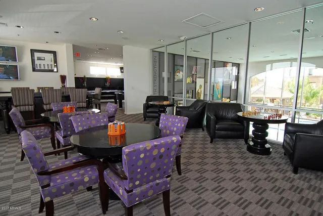 a living room with furniture a rug and a large window