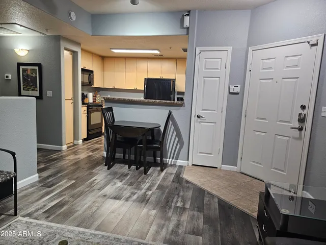 a view of a dining room with furniture and wooden floor