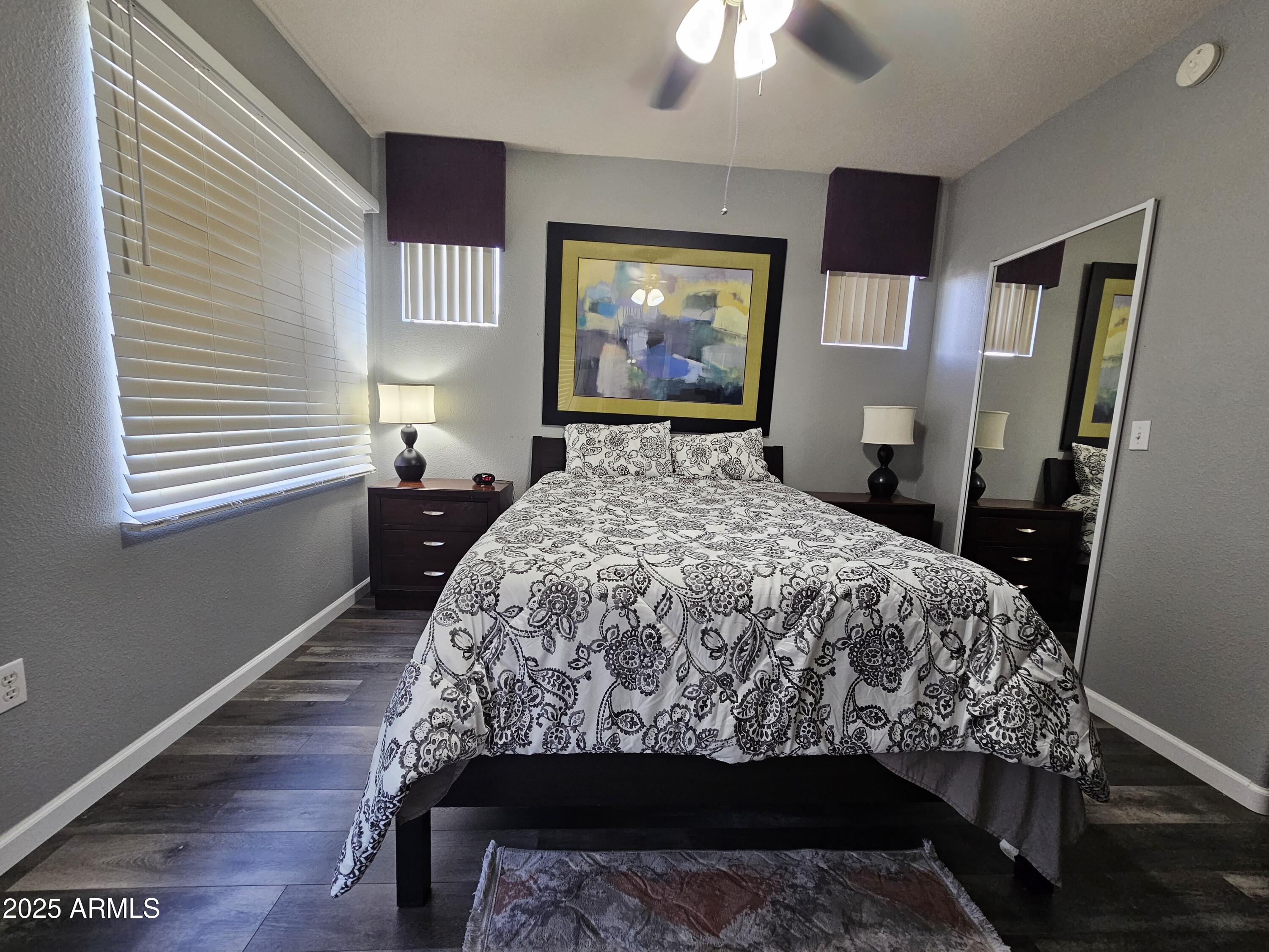 18416 North Cave Creek Road, Unit 2013 Phoenix, AZ 85032 - Photo 4 of 17 a bed sitting in a bedroom next to a window