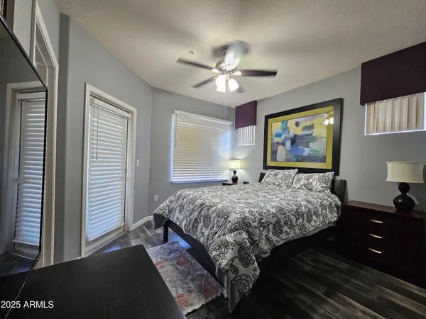 a bedroom with a bed and a chandelier