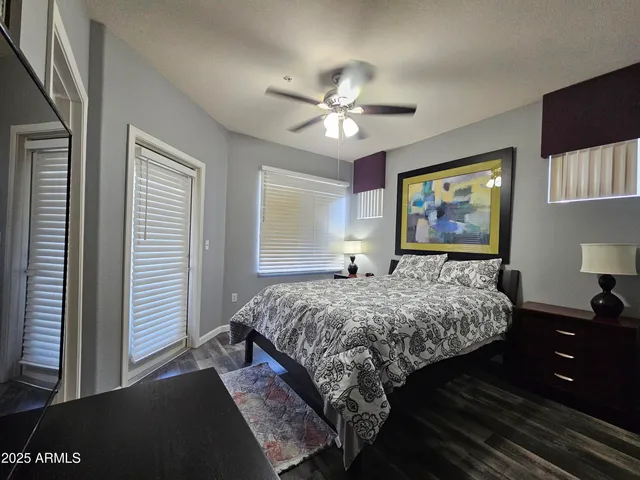 a bedroom with a bed and a chandelier