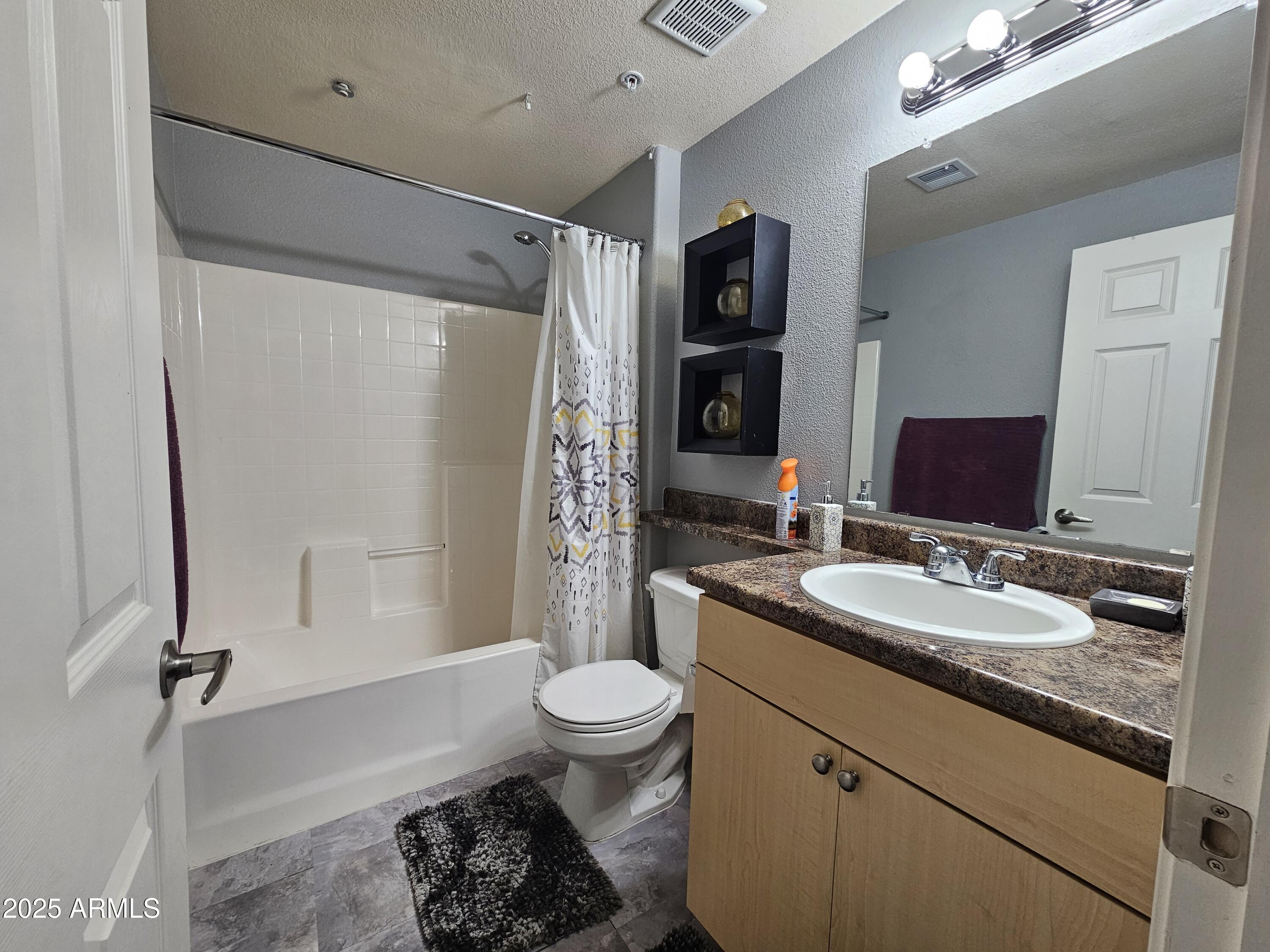 18416 North Cave Creek Road, Unit 2013 Phoenix, AZ 85032 - Photo 8 of 17 a bathroom with a granite countertop sink toilet and shower