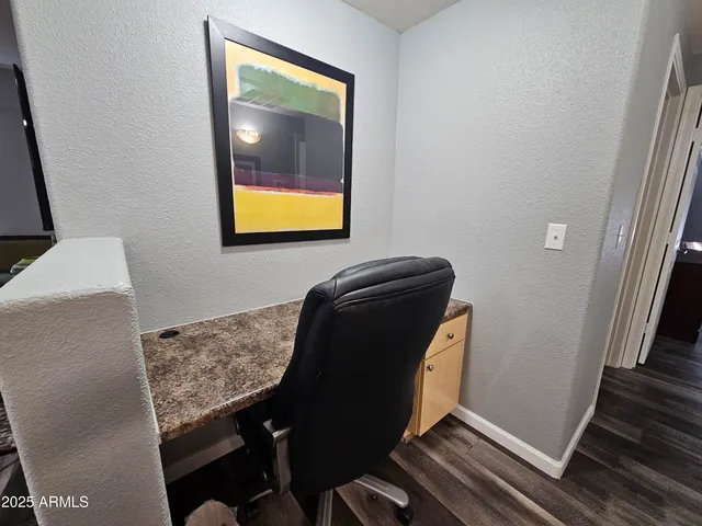 a view of workspace with wooden floor and windows
