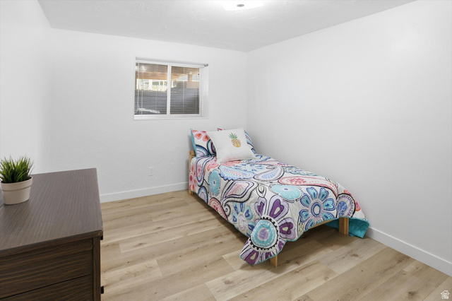 5108 South 2000th Street West Roy, UT 84067 - Photo 37 of 61 Bedroom featuring light wood-style floors and baseboards