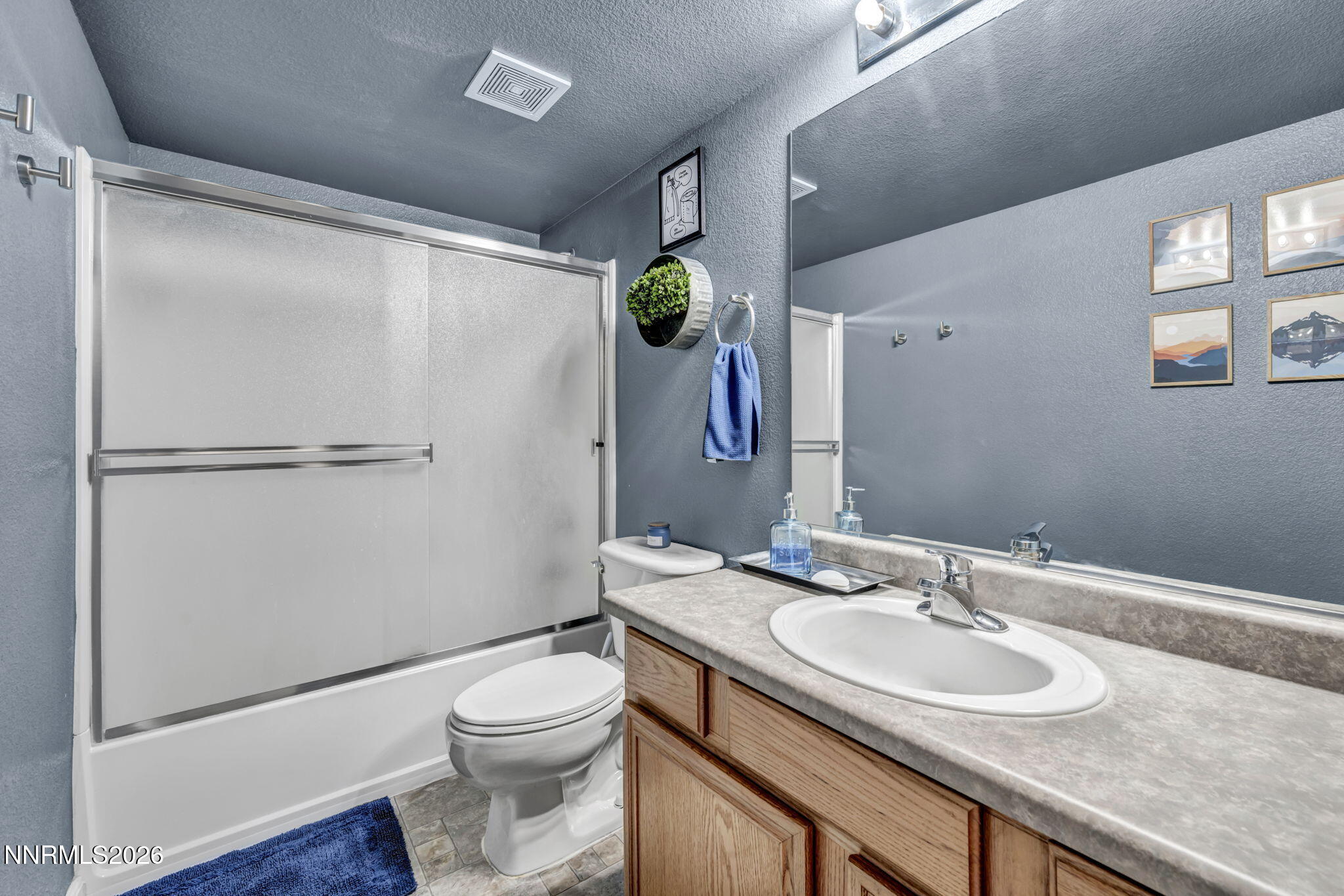 17615 Baileyville Court Reno, NV 89508 - Photo 14 of 19 a bathroom with a granite countertop sink toilet and shower