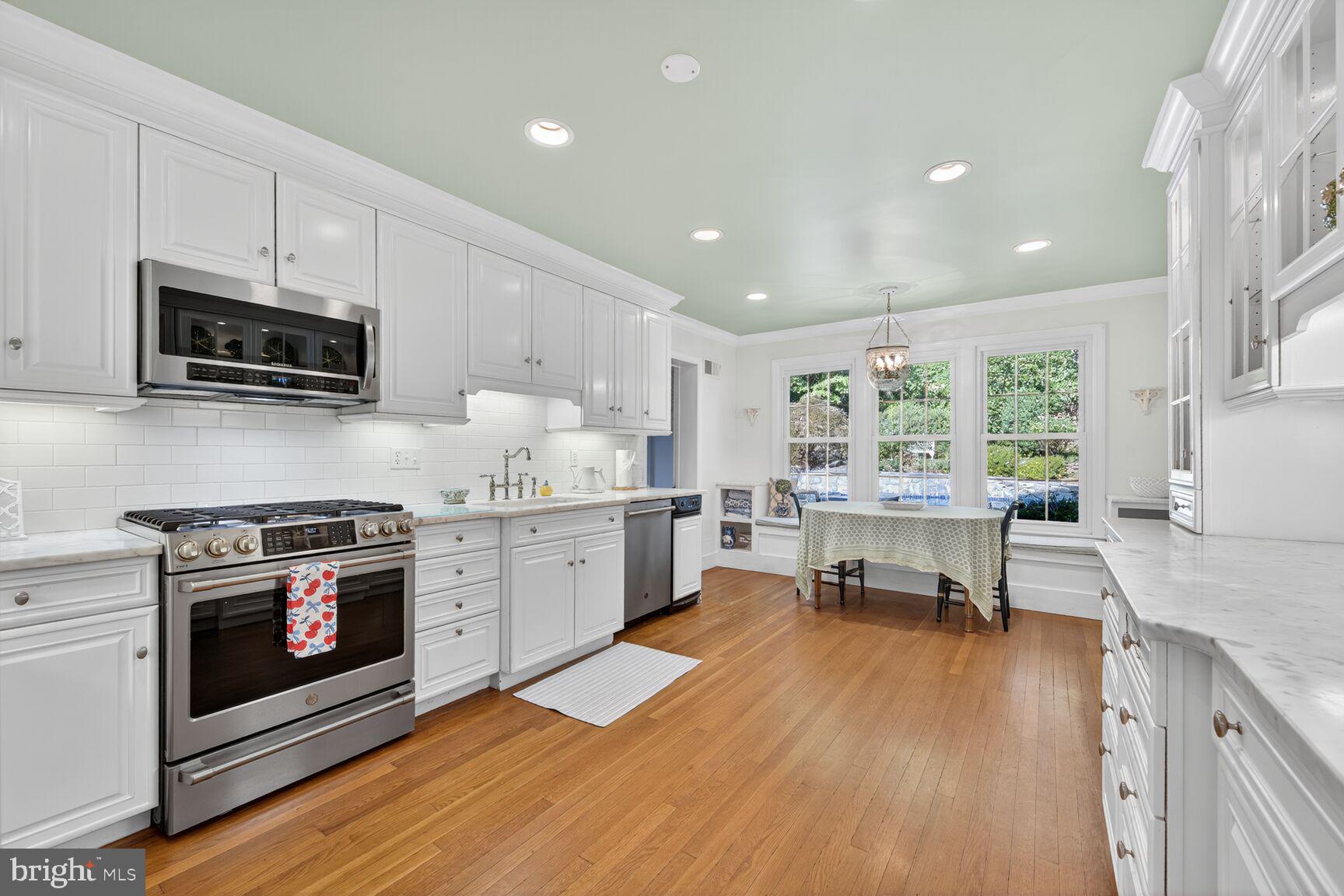 7200 Helmsdale Road Bethesda, MD 20817 - Photo 19 of 50 a kitchen with a stove a sink and a microwave
