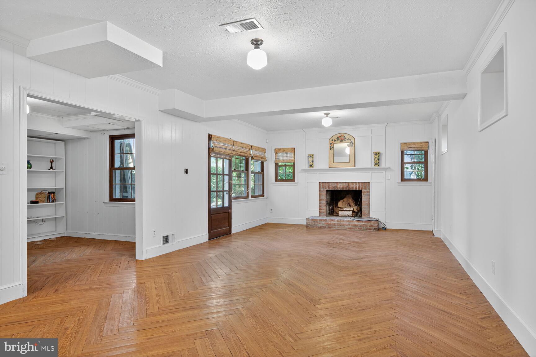 7200 Helmsdale Road Bethesda, MD 20817 - Photo 28 of 50 a view of an empty room with a fireplace and a window