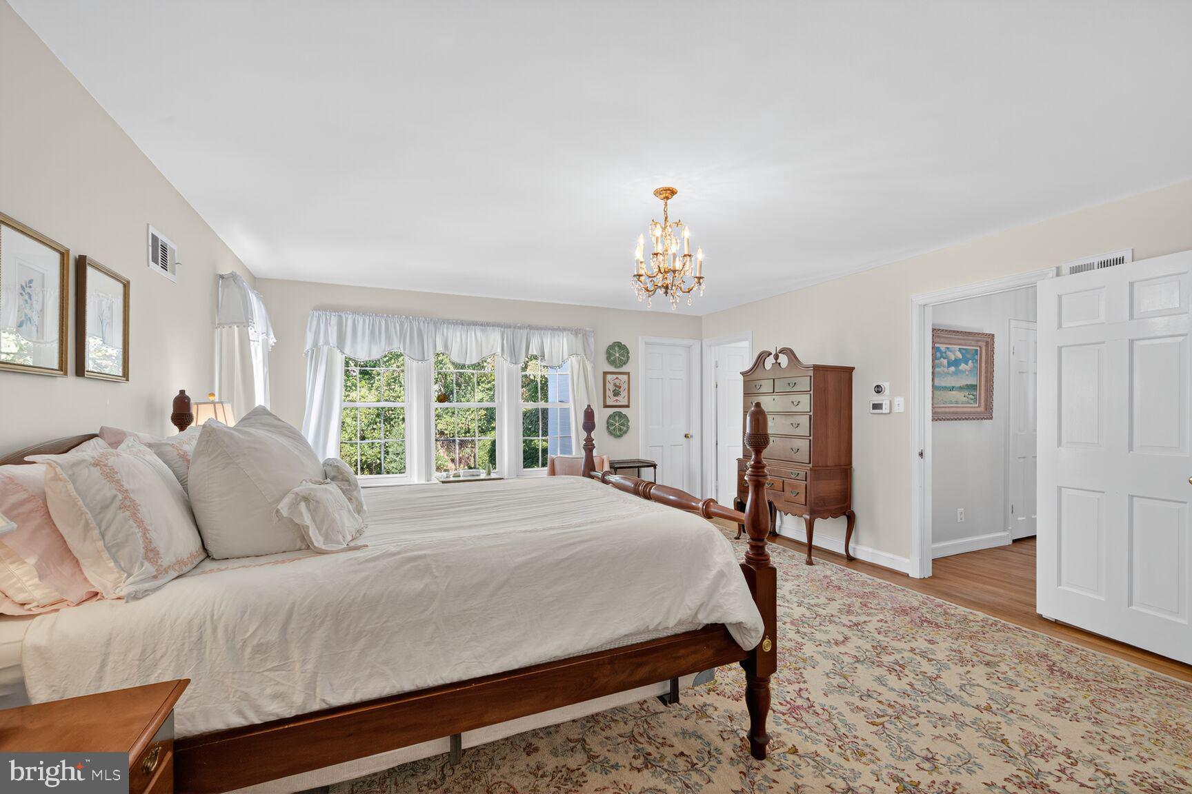 7200 Helmsdale Road Bethesda, MD 20817 - Photo 30 of 50 a spacious bedroom with a bed and a table
