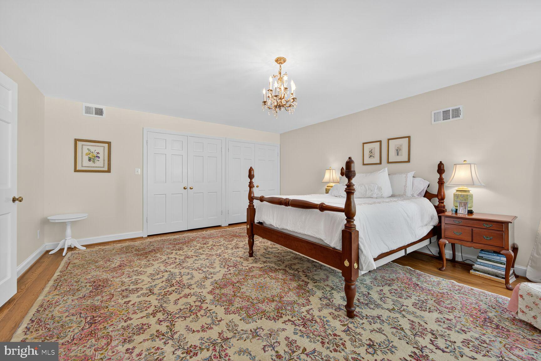 7200 Helmsdale Road Bethesda, MD 20817 - Photo 32 of 50 a bedroom with a bed and a chandelier