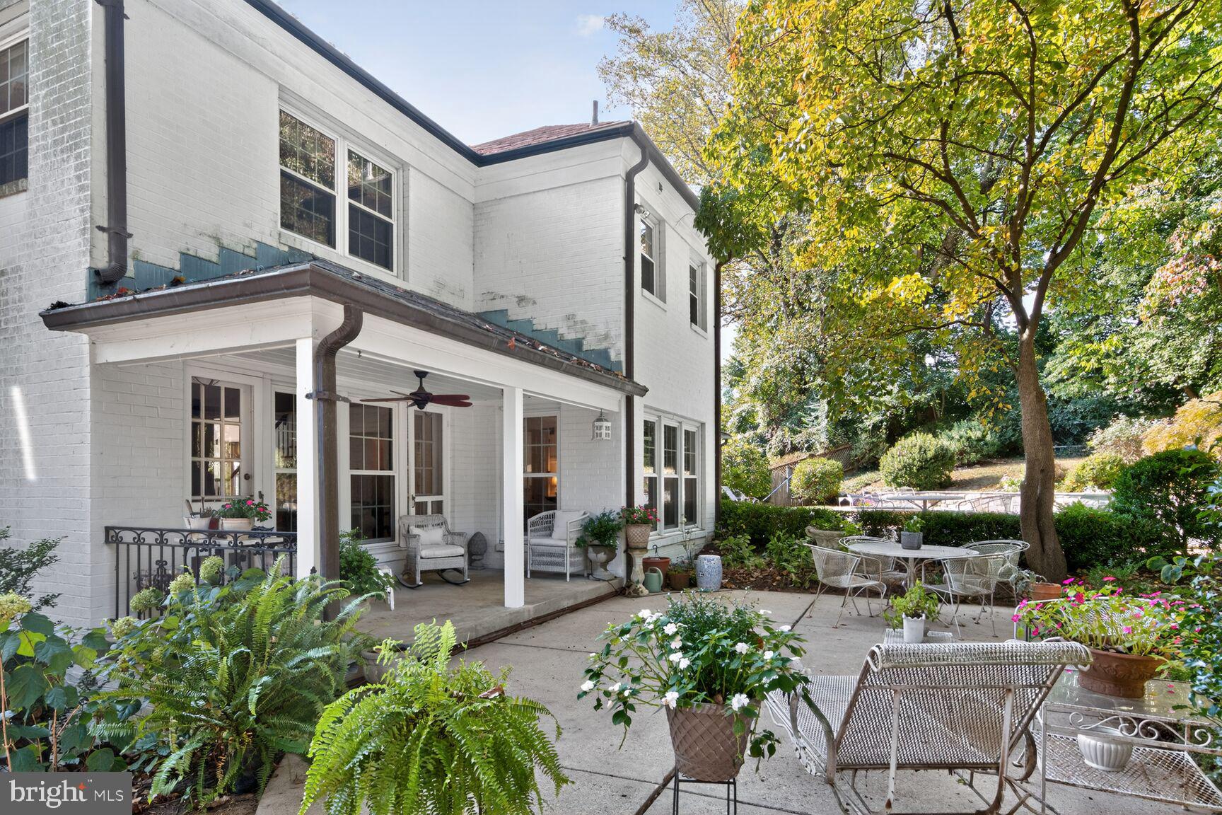 7200 Helmsdale Road Bethesda, MD 20817 - Photo 41 of 50 a view of a patio with couches table and chairs potted plants and large tree