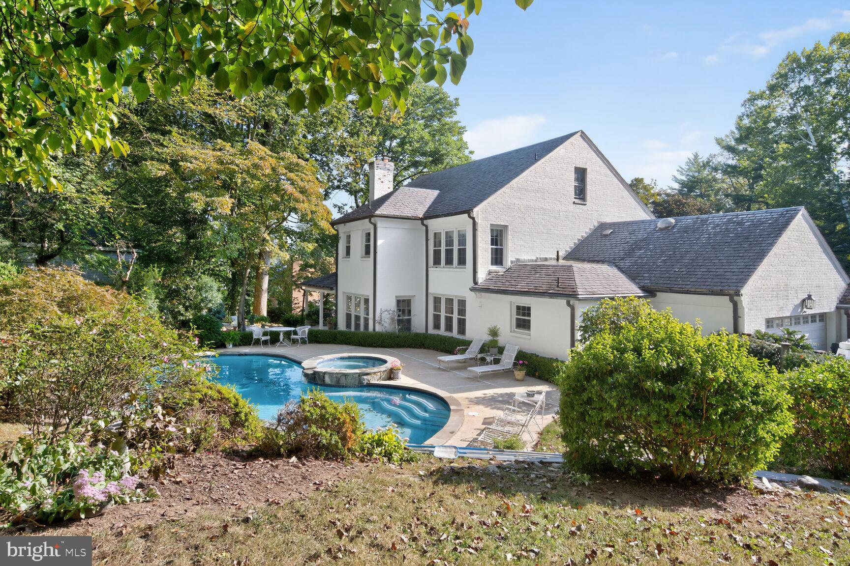 7200 Helmsdale Road Bethesda, MD 20817 - Photo 43 of 50 a front view of a house with a yard and potted plants