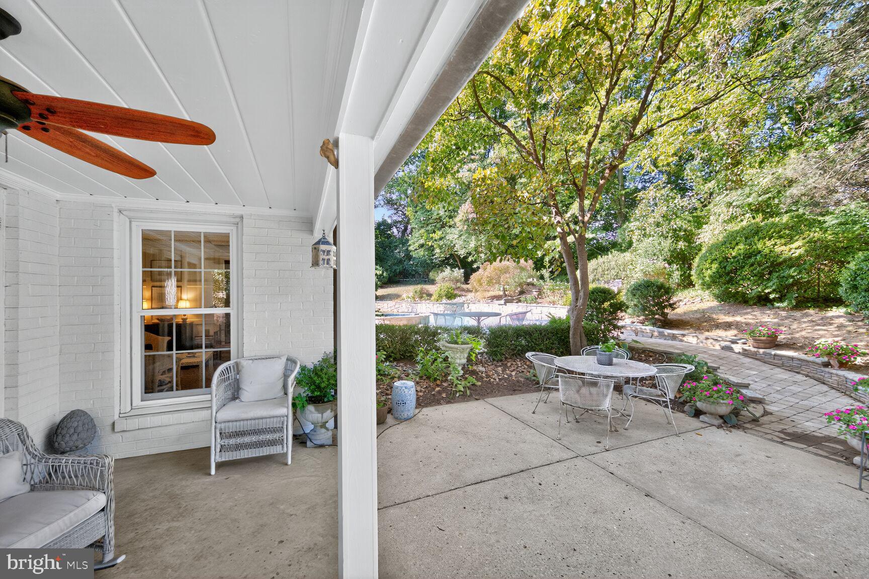 7200 Helmsdale Road Bethesda, MD 20817 - Photo 46 of 50 a view of a patio with table and chairs and potted plants
