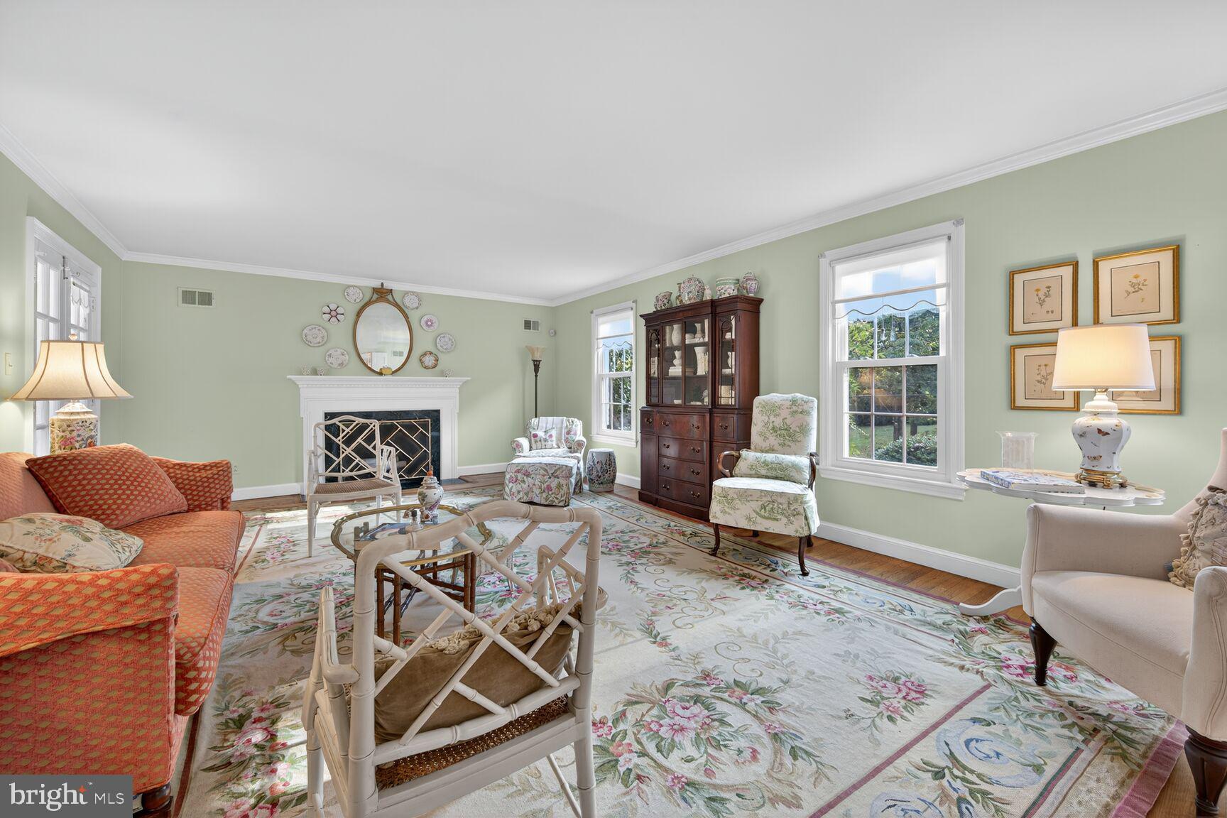 7200 Helmsdale Road Bethesda, MD 20817 - Photo 8 of 50 a living room with furniture a fireplace and large windows