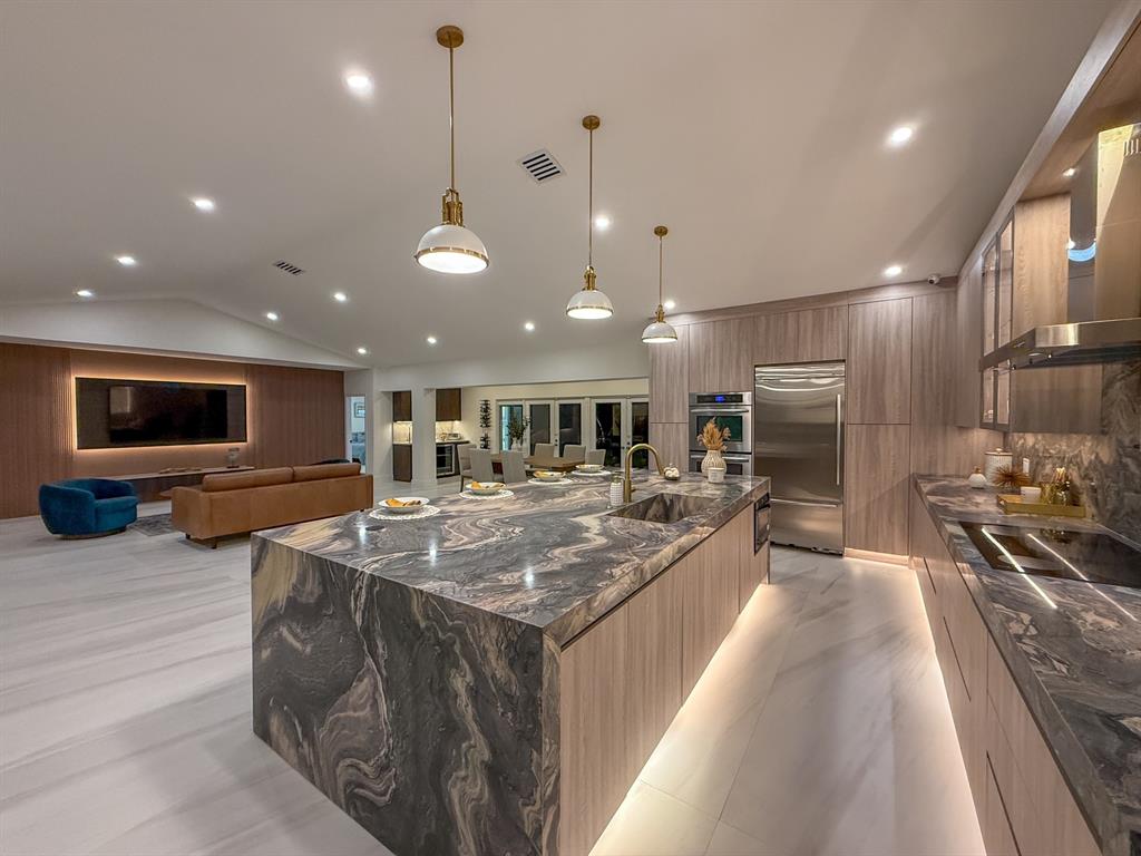 13900 Mustang Trail Southwest Ranches, FL 33330 - Photo 24 of 68 a large kitchen with stainless steel appliances kitchen island granite countertop a large counter top and a stove