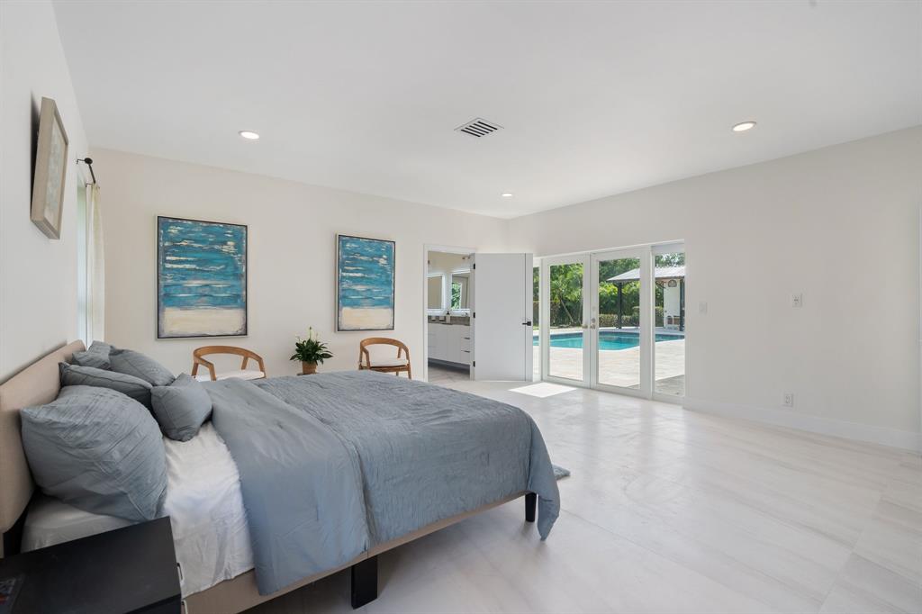 13900 Mustang Trail Southwest Ranches, FL 33330 - Photo 30 of 68 a spacious bedroom with two beds and a large window