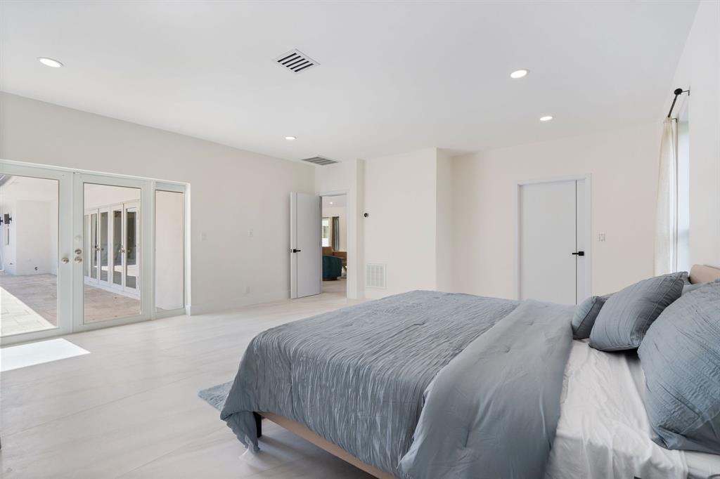 13900 Mustang Trail Southwest Ranches, FL 33330 - Photo 31 of 68 a spacious bedroom with a bed and a walk in closet