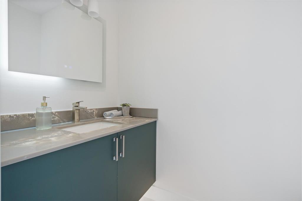 13900 Mustang Trail Southwest Ranches, FL 33330 - Photo 36 of 68 a bathroom with a granite countertop sink and a mirror