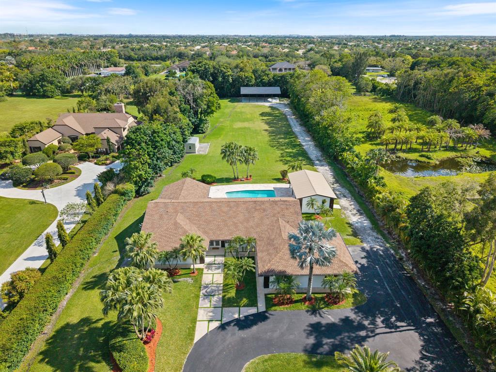 13900 Mustang Trail Southwest Ranches, FL 33330 - Photo 66 of 68 an aerial view of residential houses with outdoor space and swimming pool