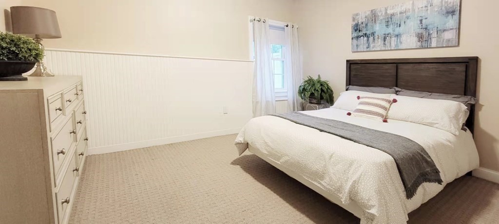 797 Highland Avenue, Unit 4 Needham, MA 02494 - Photo 17 of 21 a bedroom with a bed and a potted plant