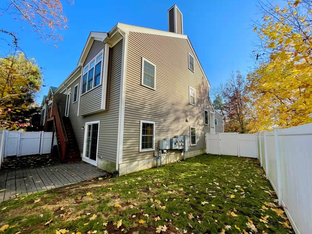 797 Highland Avenue, Unit 4 Needham, MA 02494 - Photo 19 of 21 a view of a house with a yard