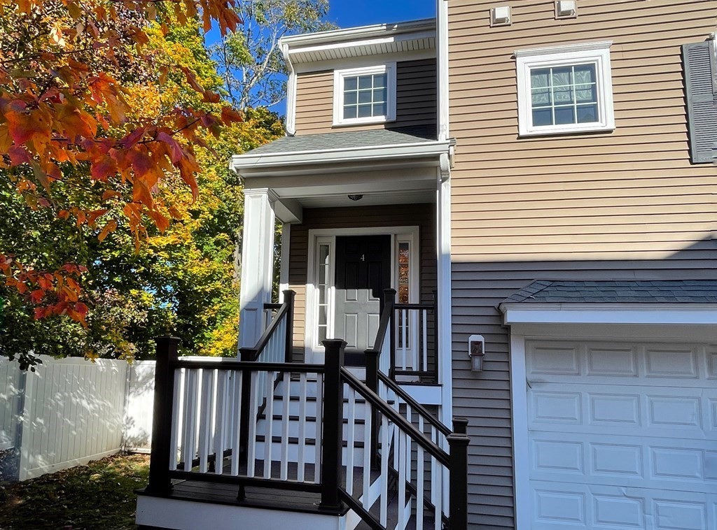 797 Highland Avenue, Unit 4 Needham, MA 02494 - Photo 2 of 21 a view of a house with wooden fence and large windows