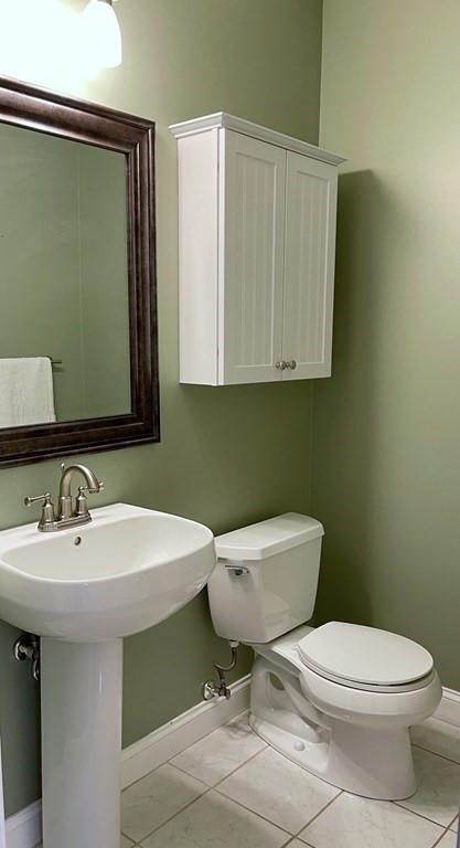 797 Highland Avenue, Unit 4 Needham, MA 02494 - Photo 8 of 21 a bathroom with a toilet a sink and mirror